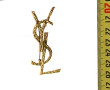 SAINTLAURENT - Broche YSL en métal doré 