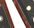 Deux archets de violon dont un signé TOU