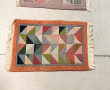 Lot de 4 petits tapis en laine à décor g