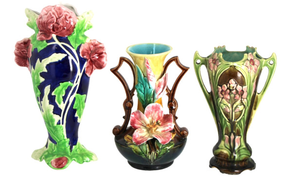 Trois vases en barbotine à décor floral,