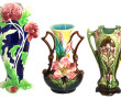 Trois vases en barbotine à décor floral,