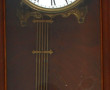 Pendule murale en bois foncé, cadran éma