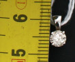 Pendentif en or gris 18 cts serti d'un d