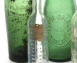 Lot de 4 bouteilles anciennes en verre e