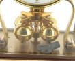 Pendulette en médal doré et balancier ro