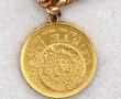 Bracelet or agrémenté d'une pièce de 20 