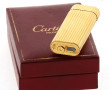 CARTIER - Briquet plaqué or en érin (un 