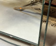 Miroir en fer forgé patiné vert, années 