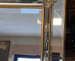 Grand miroir biseauté encadrement doré à
