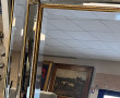 Grand miroir biseauté encadrement doré à